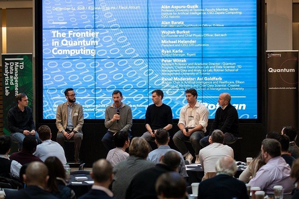 Wojciech speaking alongside Peter, Alan, Michael and Ryan